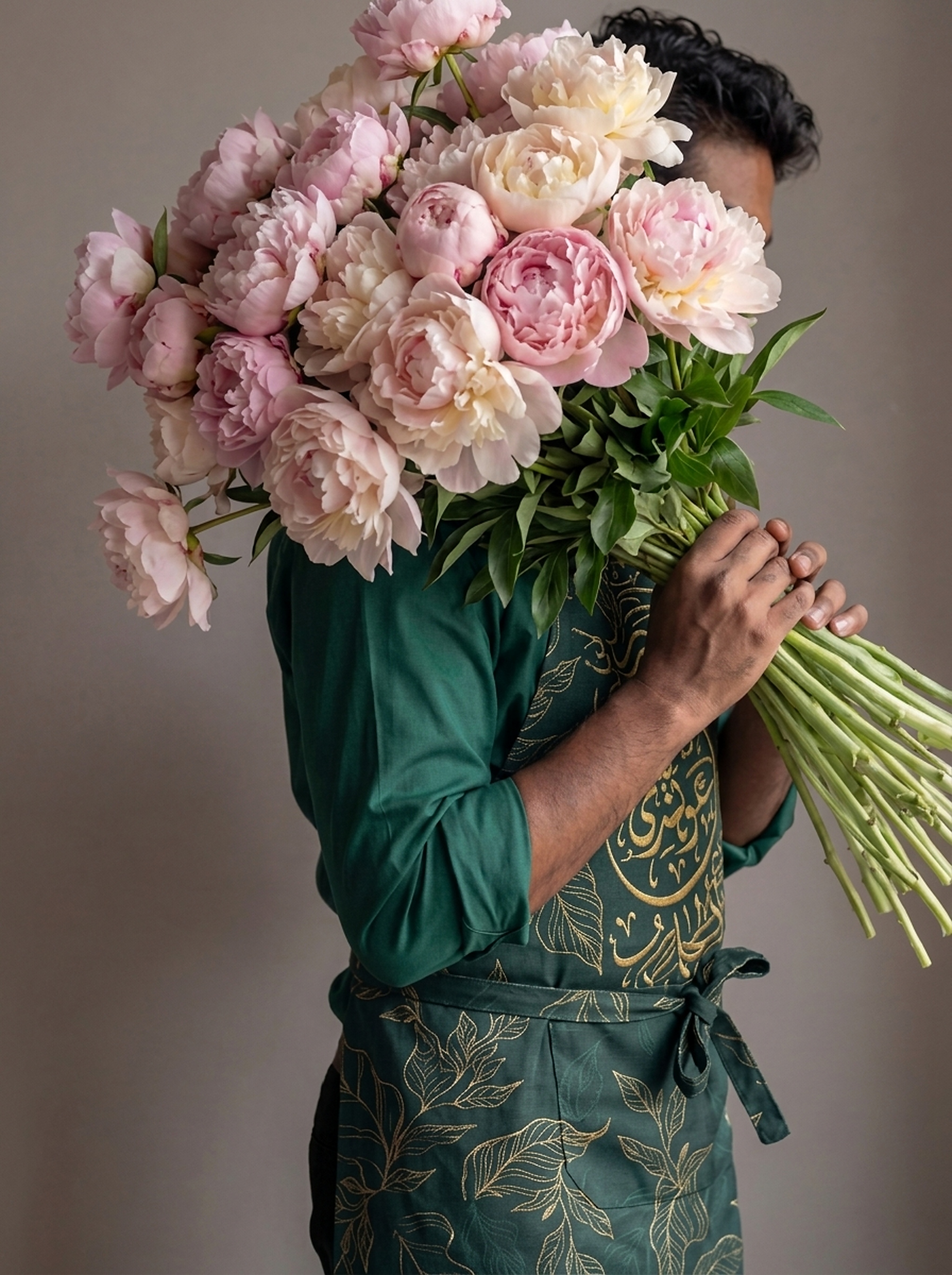 Plaza Hollandi professional florist holding fresh blooming peonies